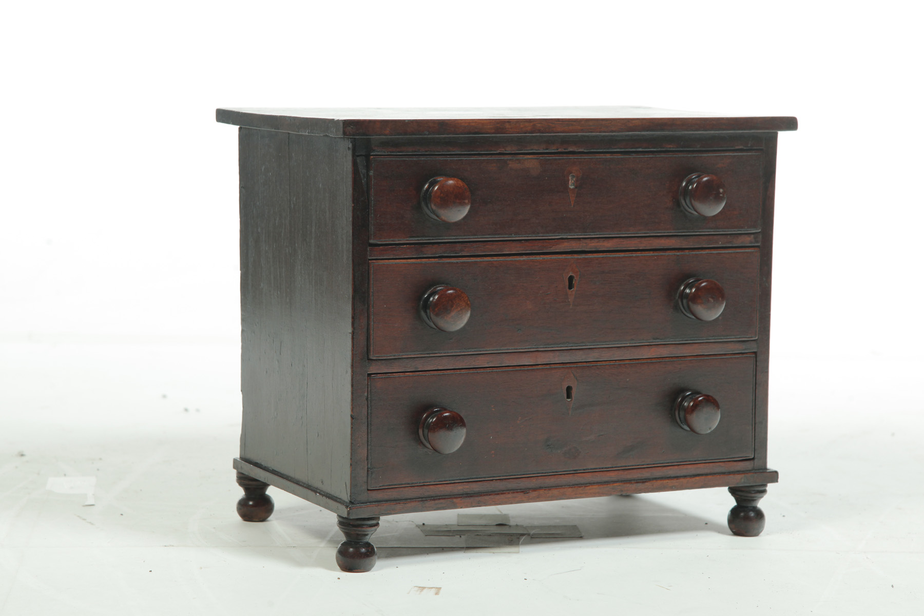 Appraisal: MINIATURE SHERATON THREE-DRAWER CHEST American nd quarter- th century walnut