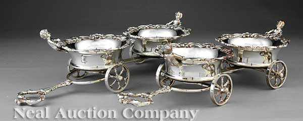 Appraisal: A Pair of Silverplate Wine Trolleys each fitted with two