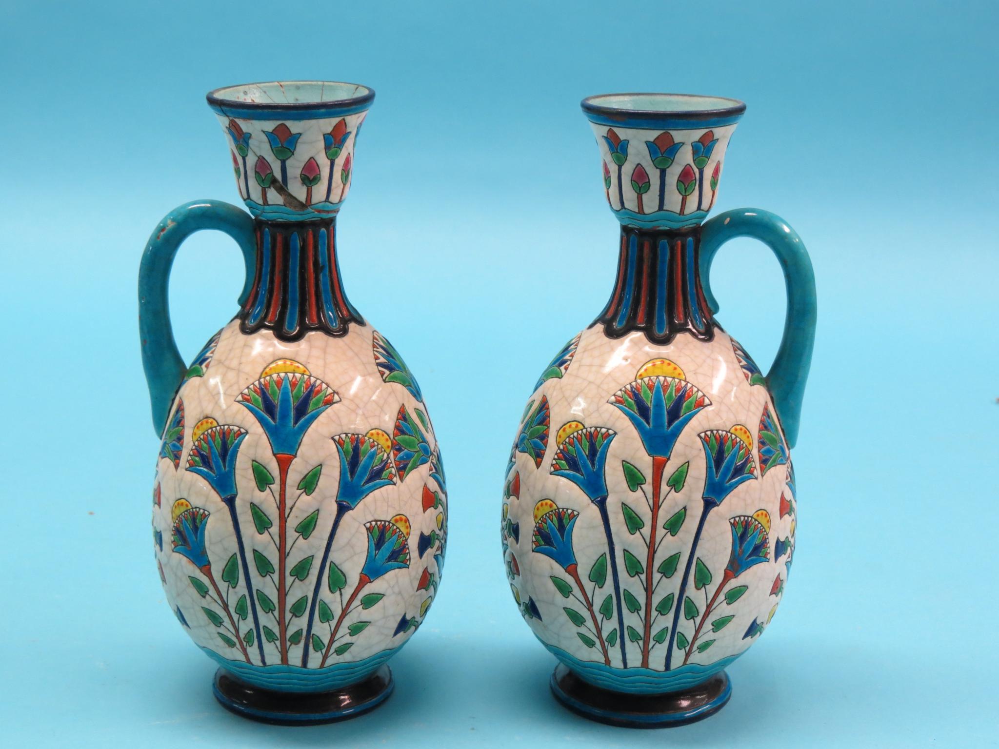 Appraisal: A pair of Longwy earthenware ewers brightly enamelled in -