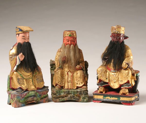 Appraisal: Carved wooden Chinese temple figures three ominous to happy seated