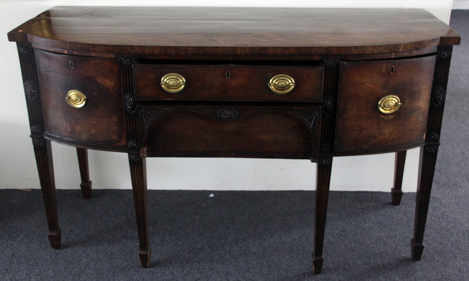 Appraisal: A George III mahogany sideboard the D-shaped top above a