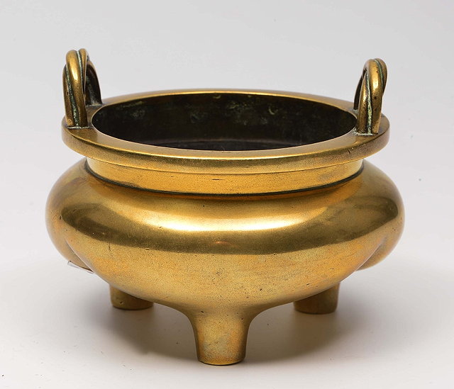 Appraisal: A CHINESE BRONZE DING with rope-twist handles on three supports