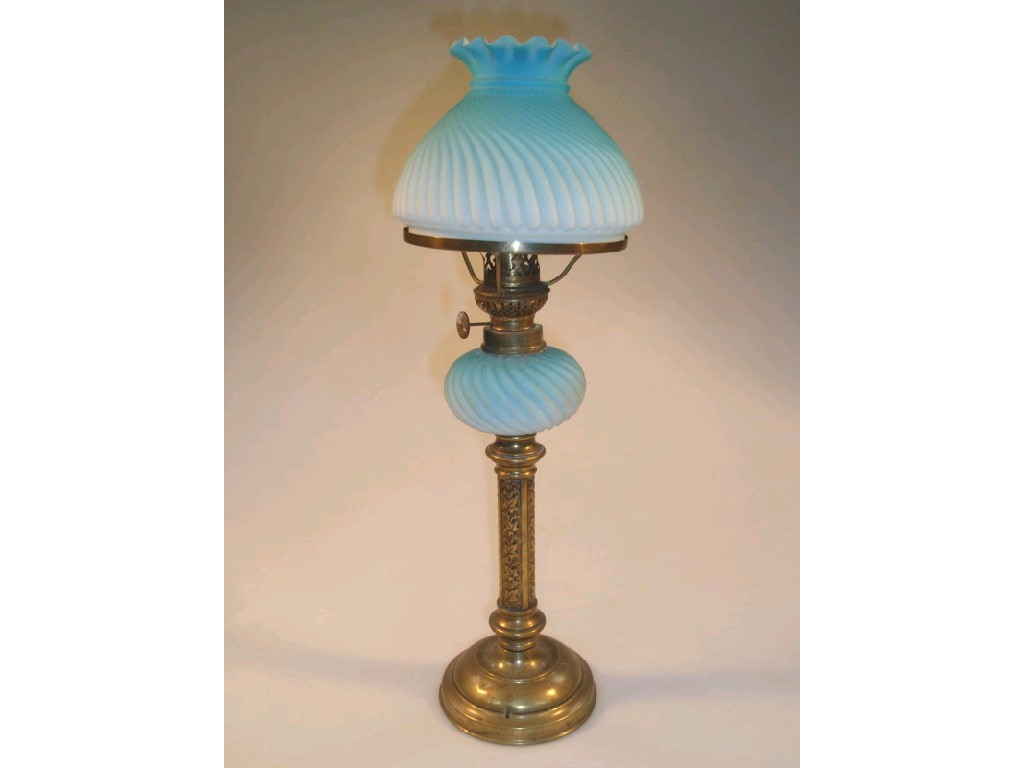 Appraisal: A Victorian oil lamp with a brass column supporting a