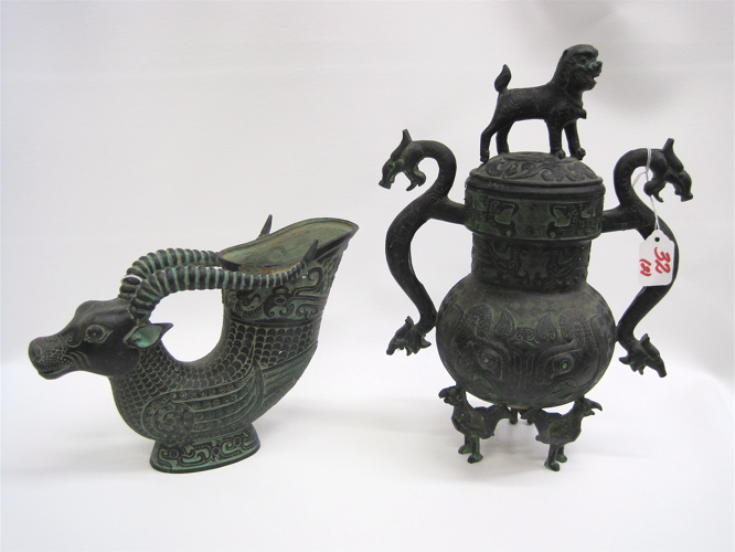 Appraisal: TWO CHINESE METAL PATINATED VESSELS a figural antelope with cup-like