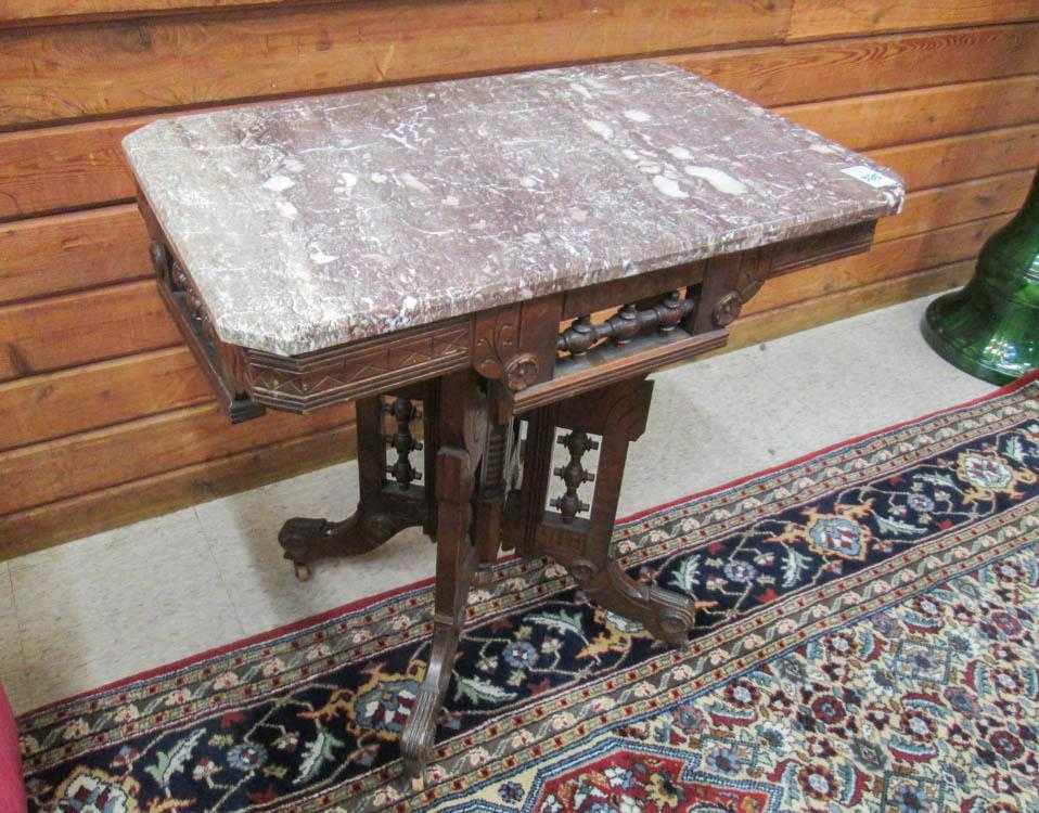 Appraisal: VICTORIAN MARBLE-TOP WALNUT LAMP TABLE Eastlake design American last quarter