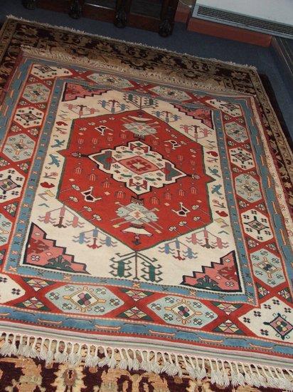 Appraisal: AN ORIENTAL BRIGHTLY COLOURED RUG - decorated a central medallion