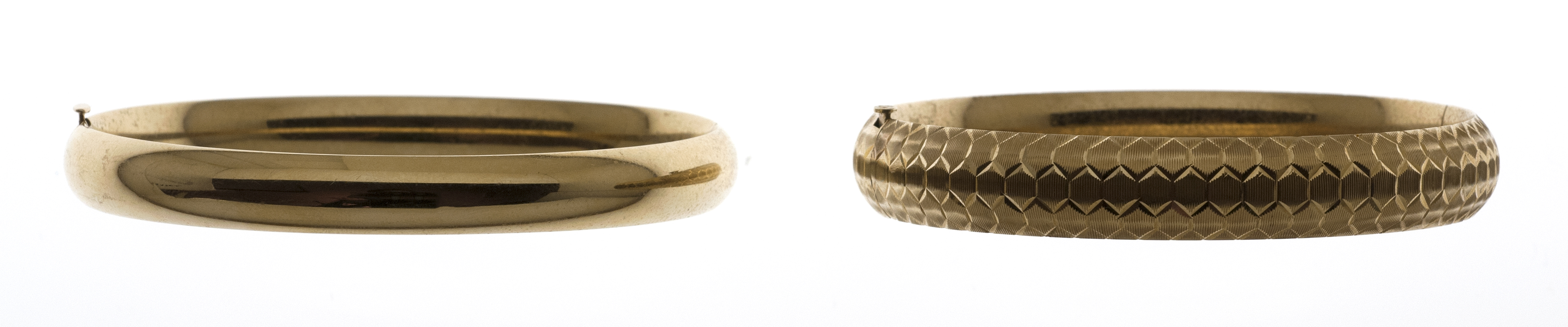 Appraisal: TWO KT GOLD BANGLE BRACELETS One circular with engraved honeycomb