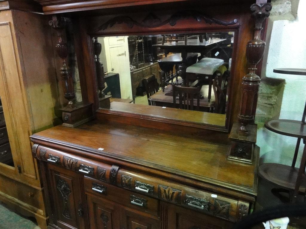 Appraisal: An Edwardian walnut sideboard enclosed by an arrangement of cupboards