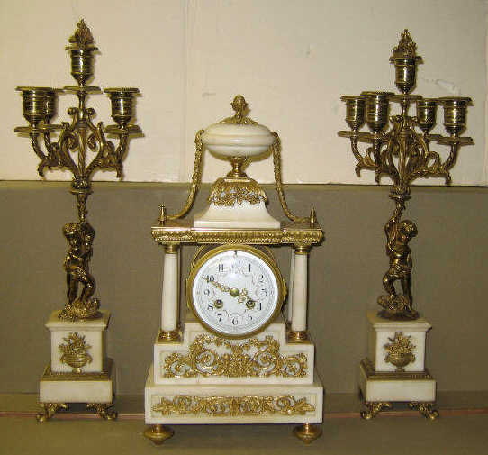 Appraisal: ORMOLU AND MARBLE THREE-PIECE CLOCK GARNITURE Bracket pedestal and columnar