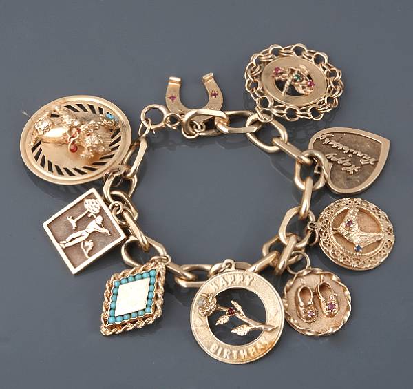 Appraisal: A gold charm bracelet with nine charms g gross length