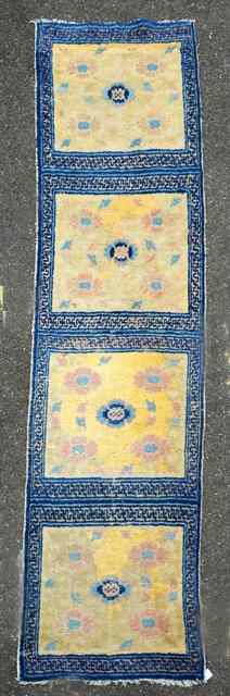 Appraisal: A NORTH WEST CHINESE NINGHSIA YELLOW GROUND RUNNER decorated four