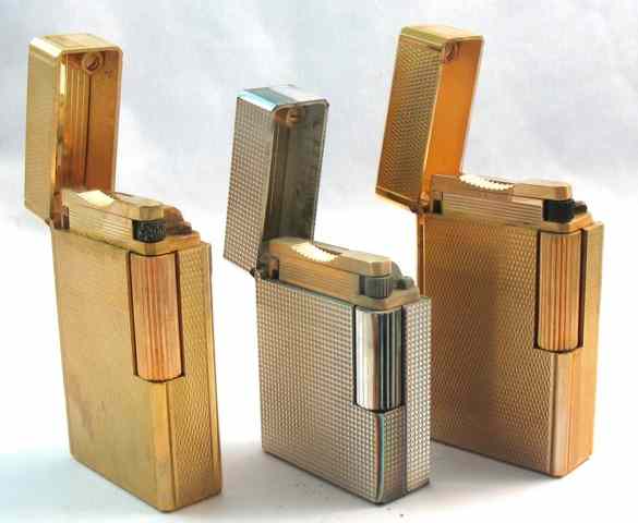 Appraisal: THREE S T DUPONT FRENCH COLLECTIBLE LIGHTERS two are gold