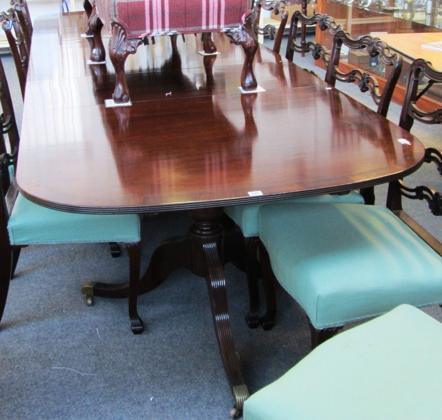 Appraisal: A Regency style rosewood banded mahogany triple pillar dining table