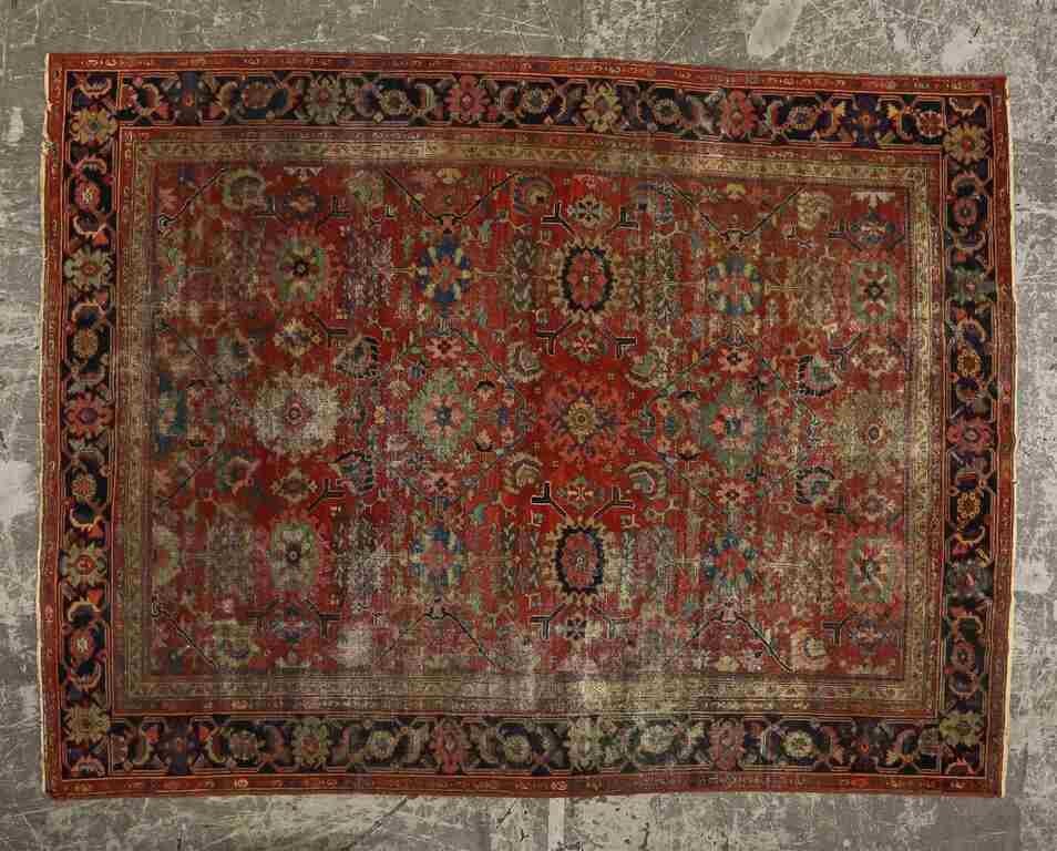 Appraisal: Persian rug Polychromatic medallion against a red field Heavy fading