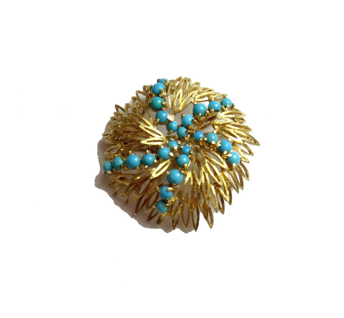 Appraisal: A gold and imitation turquoise set brooch in a spiral