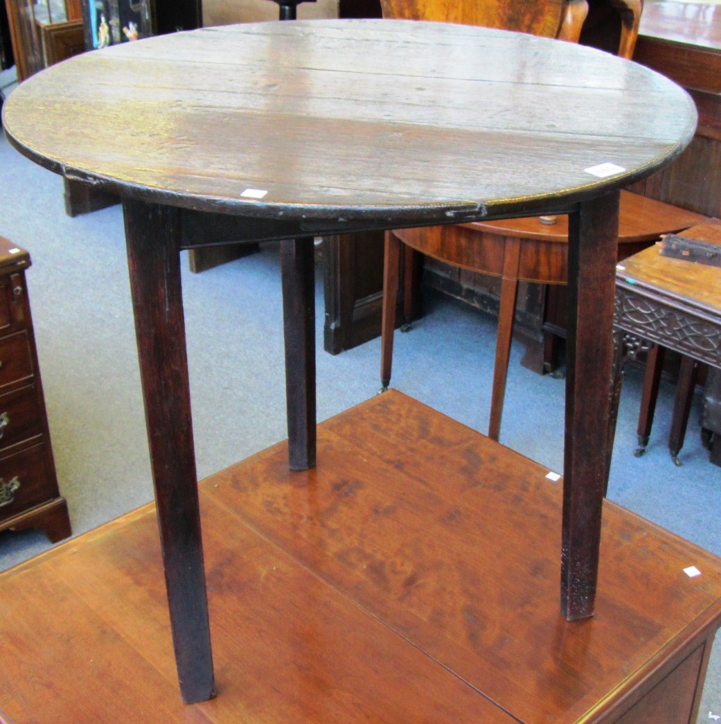 Appraisal: An th century oak cricket table the circular top on