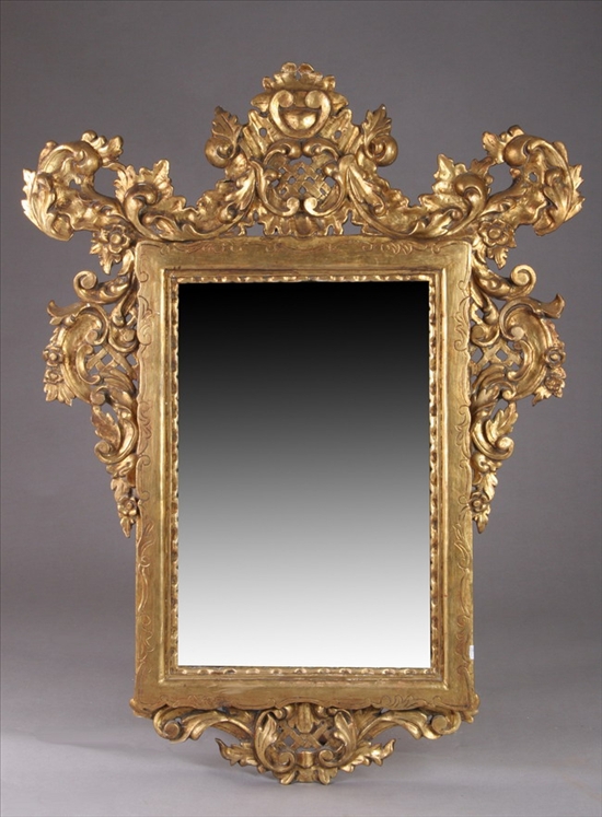 Appraisal: CONTINENTAL CARVED GILTWOOD WALL MIRROR th century Cartouche crest with