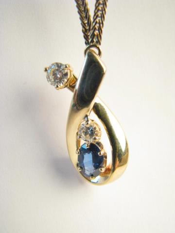 Appraisal: A K yellow gold necklace with oval sapphire center stone