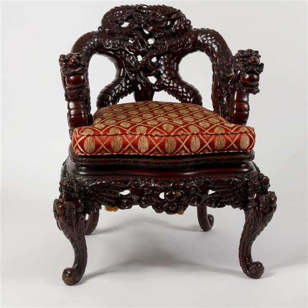 Appraisal: Heavily carved Chinese hardwood chair the arms terminating in dragons