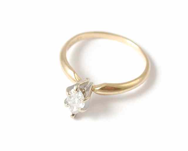 Appraisal: DIAMOND AND FOURTEEN KARAT GOLD SOLITAIRE RING featuring a single