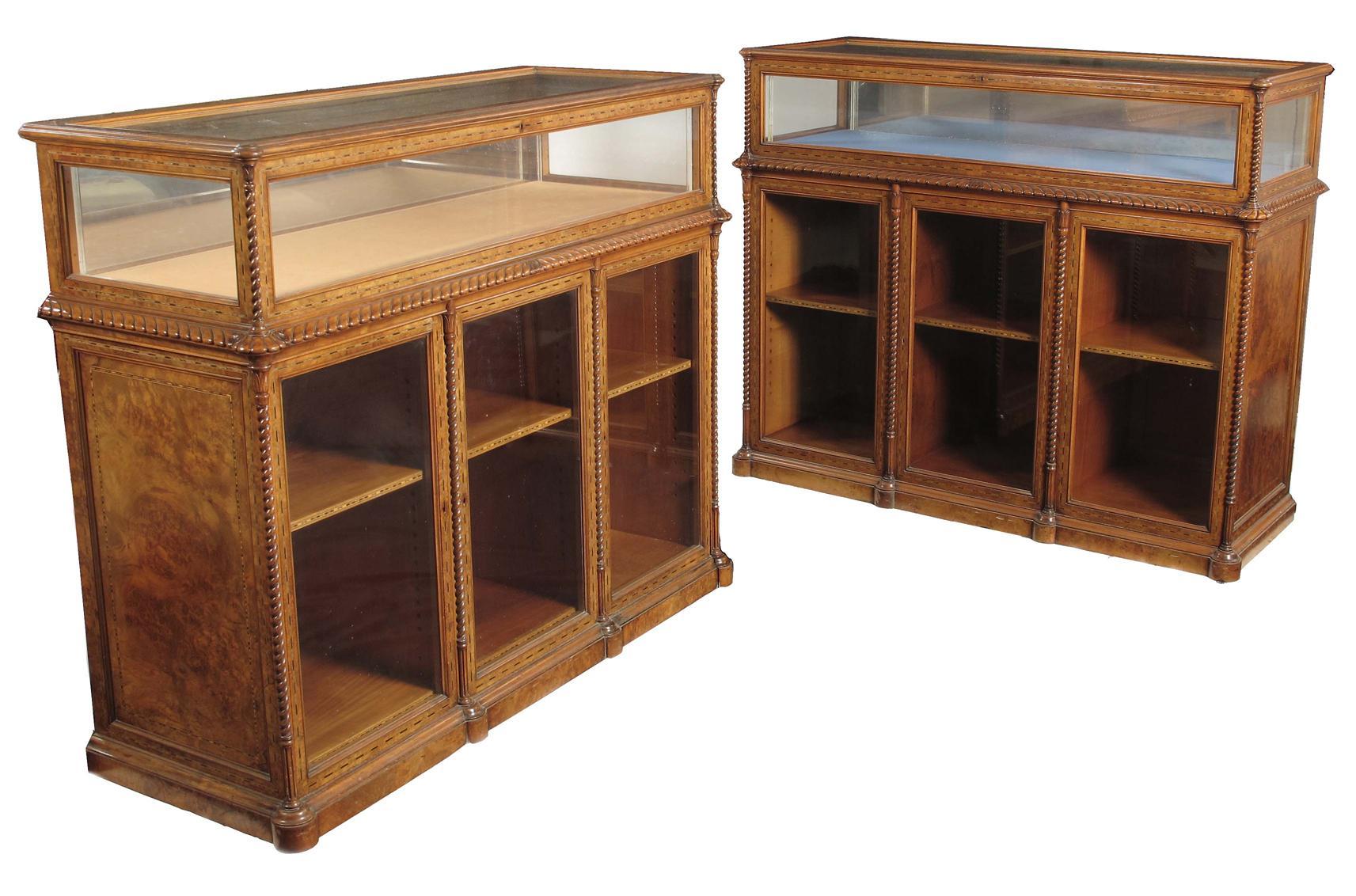 Appraisal: A near pair of Victorian walnut display cabinets attributed to