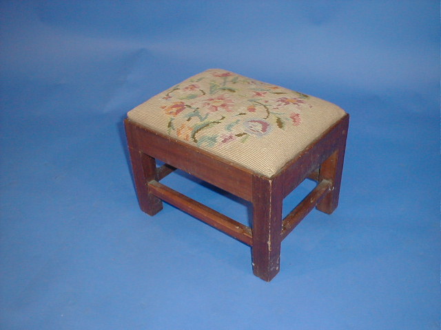 Appraisal: A small mahogany stool with wool work top