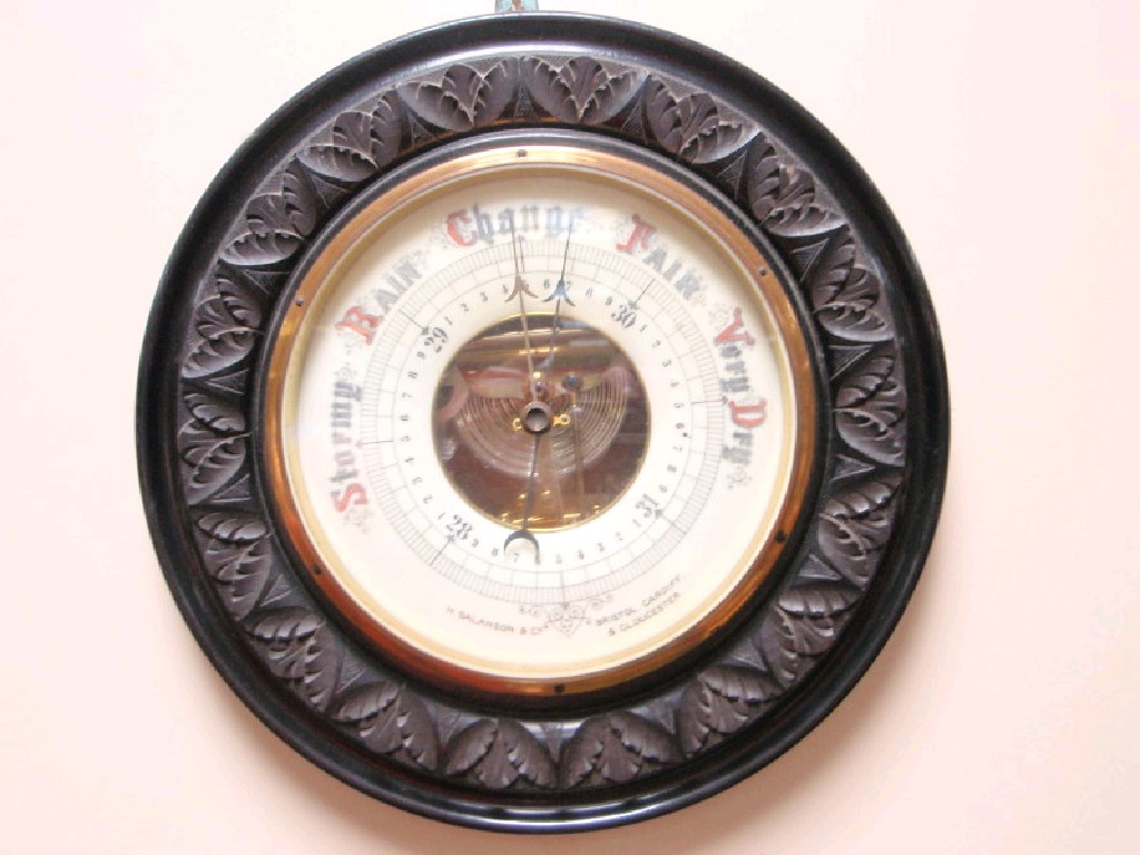 Appraisal: An Edwardian carved and ebonised anaroid barometer retailed by H