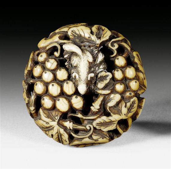 Appraisal: A IVORY MANJU OF A SQUIRREL AND GRAPE-VINES Japan th