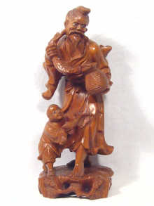 Appraisal: A carved boxwood figure of a fisherman with a young