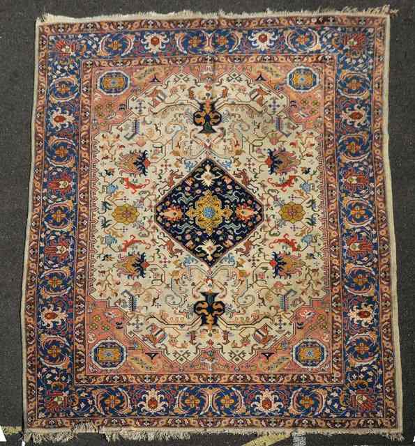 Appraisal: A PERSIAN MULTICOLOURED CARPET decorated a central deep blue medallion