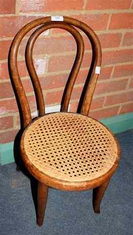 Appraisal: A THONET BENTWOOD AND CANE PANELLED CHILD'S CHAIR with hooped