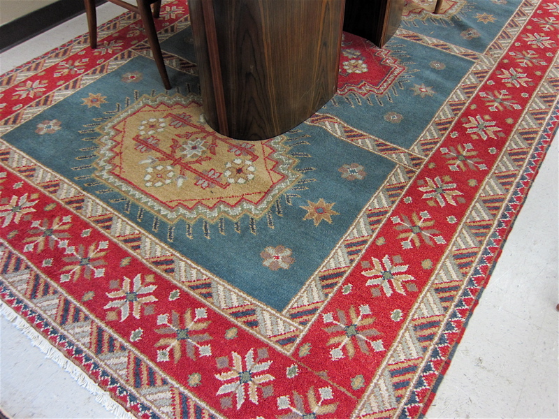 Appraisal: HAND KNOTTED ORIENTAL CARPET Indo-Caucasian featuring three geometric medallions each