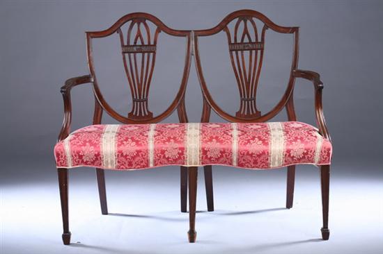 Appraisal: GEORGE III STYLE DOUBLE SHIELD-BACK MAHOGANY SETTEE th century pink