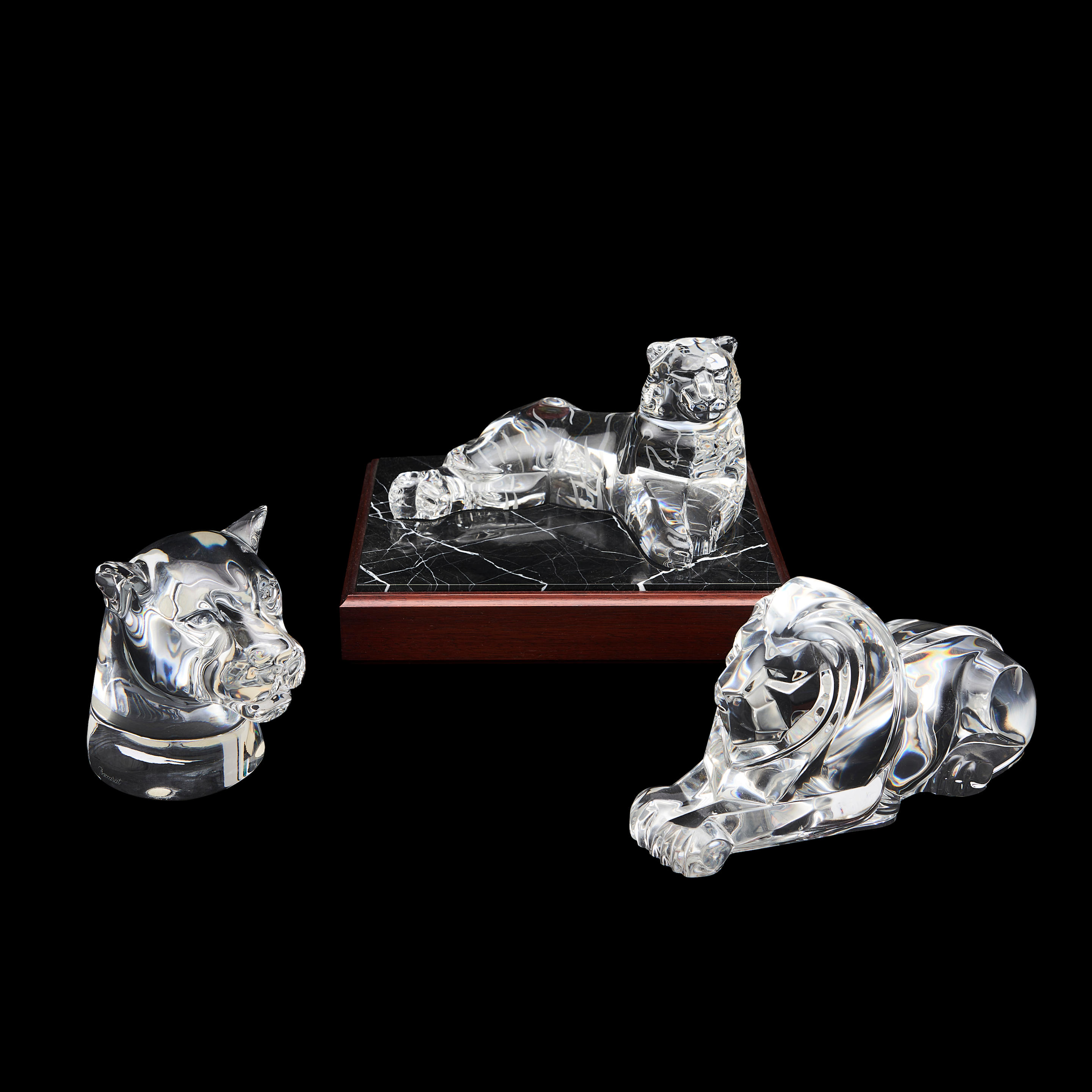 Appraisal: THREE CONTEMPORARY GLASS BIG CAT FIGURES a Steuben reclining tiger