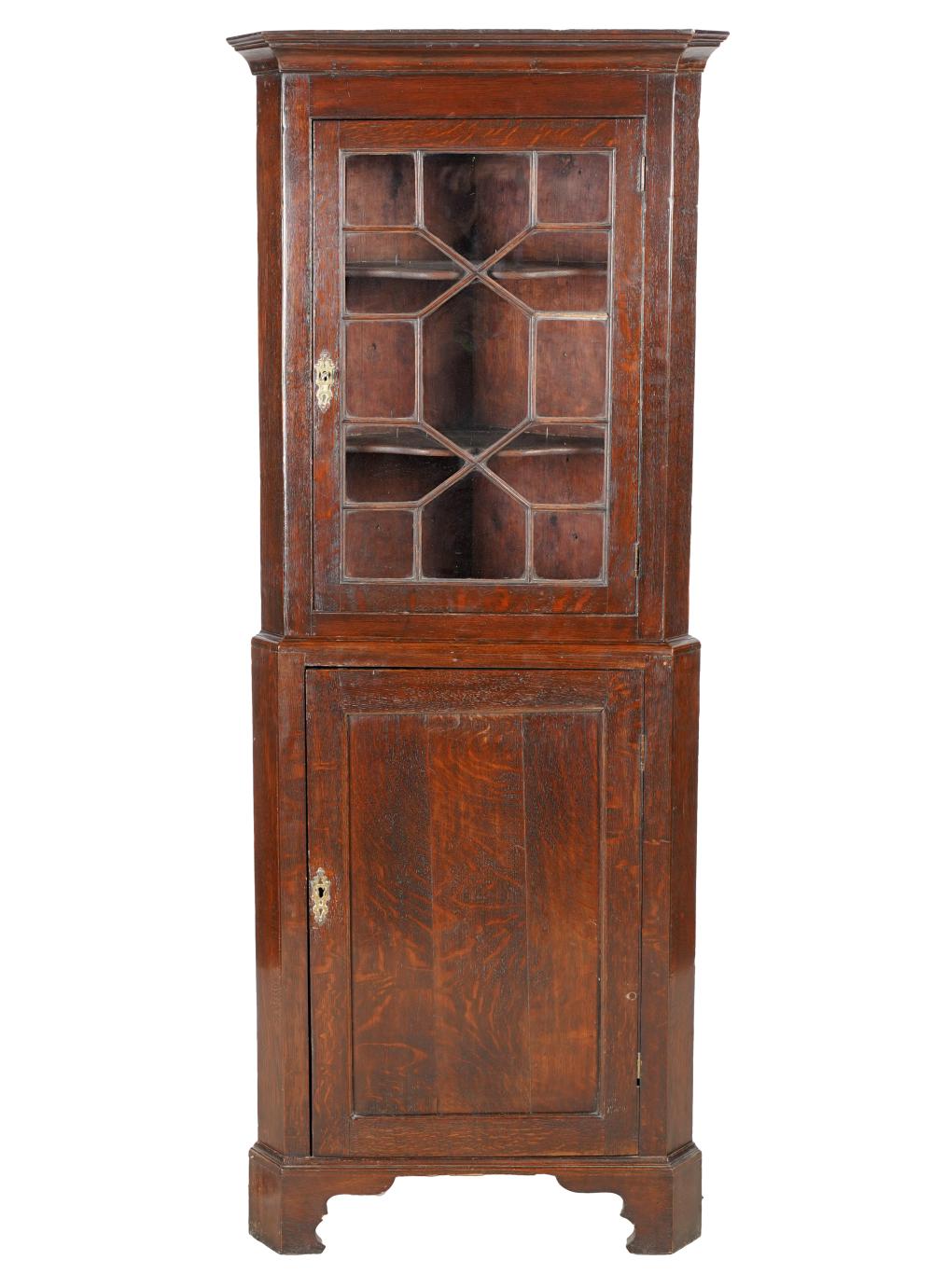 Appraisal: GEORGIAN-STYLE OAK CORNER CABINETin two parts the upper section with