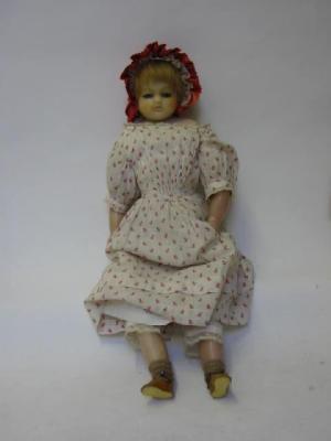 Appraisal: A poured wax shoulder head girl doll with fixed blue