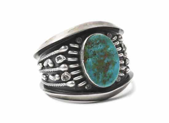 Appraisal: A Southwestern Style Sandcast Sterling Silver and Turquoise Cuff Bracelet