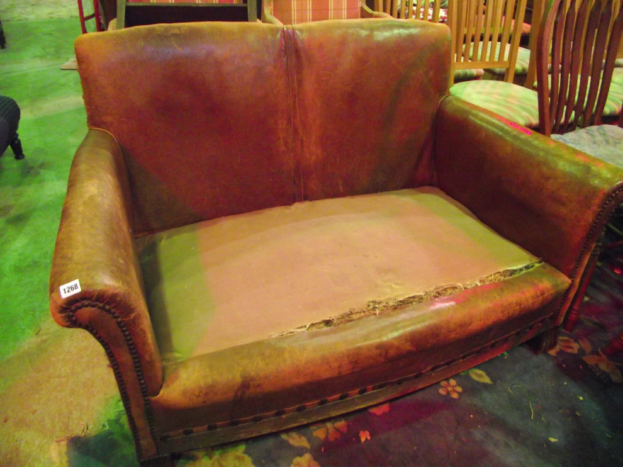 Appraisal: An early th century two seat sofa worn tan leather