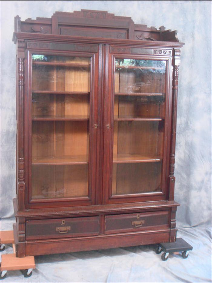 Appraisal: door walnut Victorian bookcase crested top drawer base h w