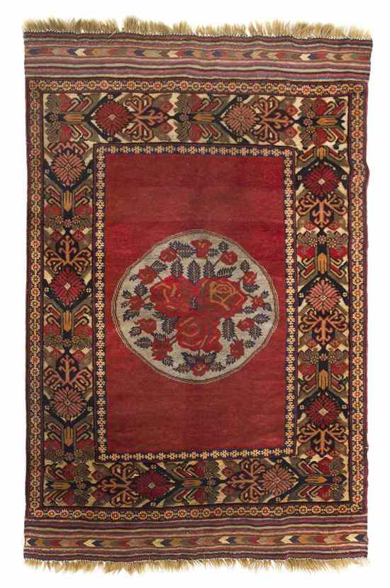 Appraisal: An Afghan Wool Rug having an oval center medallion containing