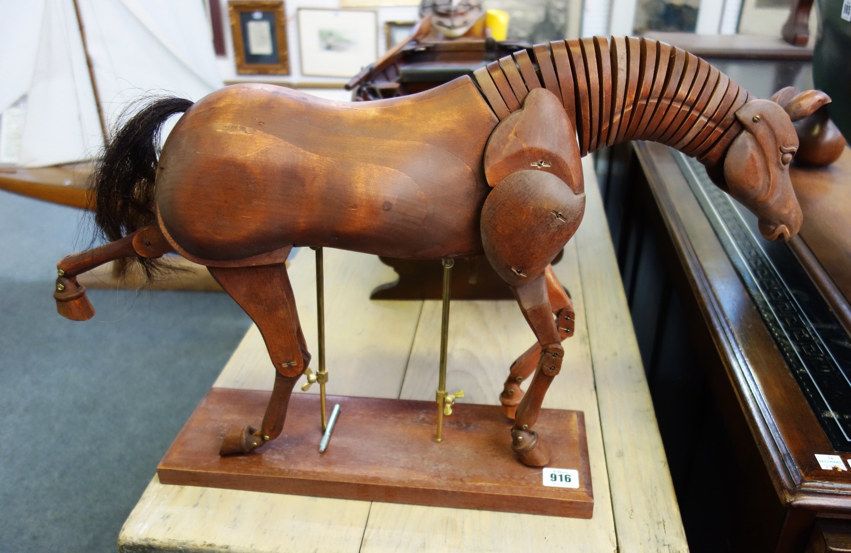 Appraisal: A modern hardwood model of an articulated horse raised on