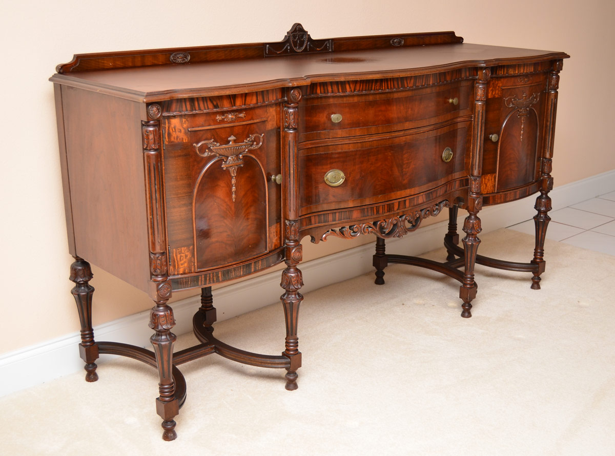 Appraisal: WEST END FURNITURE MAHOGANY CARVED SIDEBOARD Carved crest serpentine front