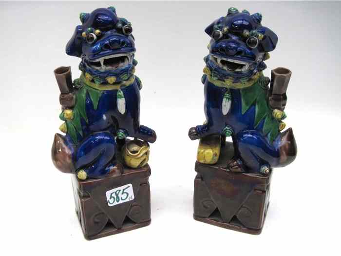 Appraisal: PAIR CHINESE POTTERY FOO LIONS with male guard and the