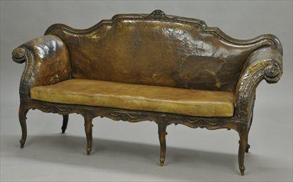 Appraisal: ITALIAN ROCOCO LEATHER-UPHOLSTERED SETTEE Husk carved cresting rail above padded