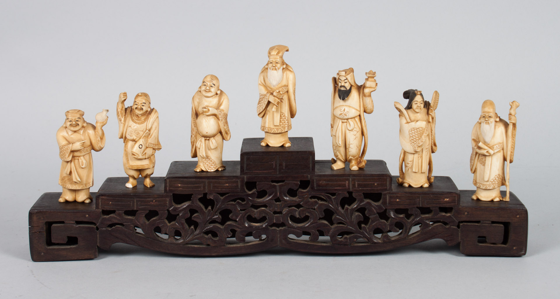 Appraisal: Seven Japanese carved ivory immortals stand carved and ink highlighted