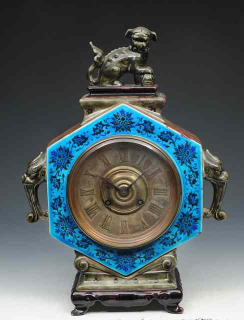 Appraisal: AN AESTHETIC MOVEMENT POTTERY CASED MANTEL CLOCK having a Roman