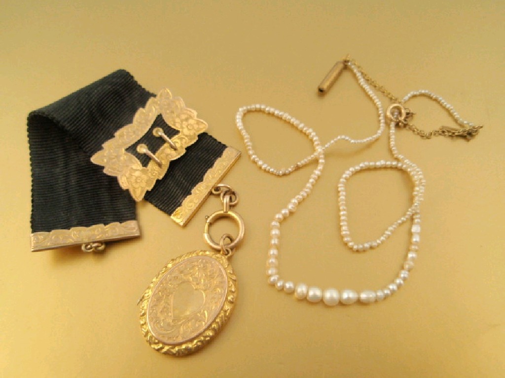 Appraisal: A Victorian ct locket on moir strap with ct gold