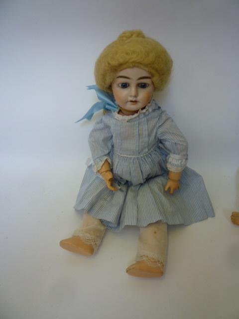 Appraisal: A German bisque head girl doll with fixed blue glass