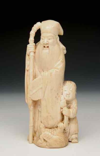 Appraisal: A JAPANESE IVORY OKIMONO of a standing figure of Jurojin