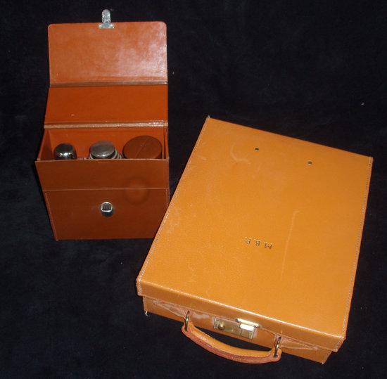 Appraisal: A cased cocktail set comprising flask and shaker together with